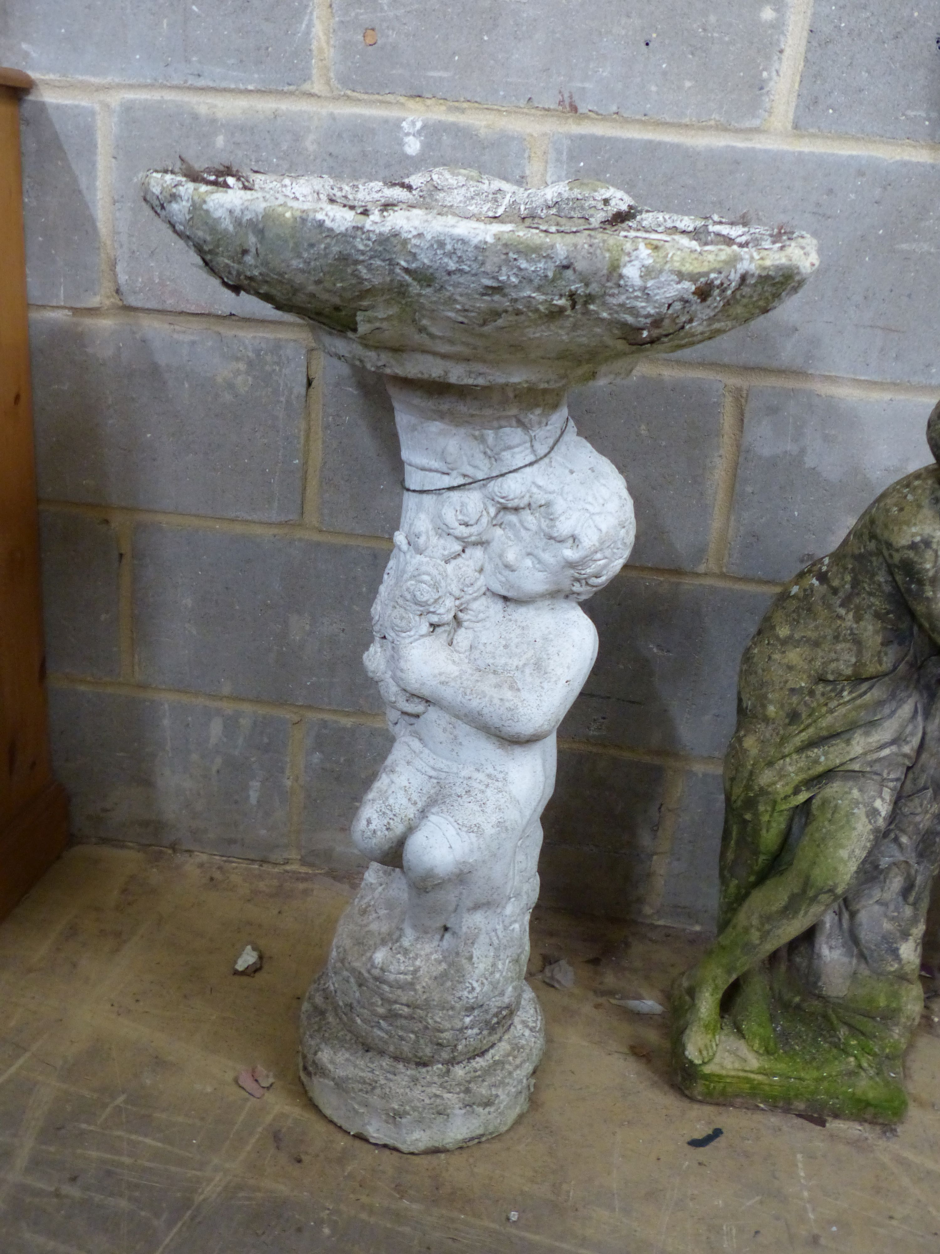 Two reconstituted stone garden statues and a bird bath, largest height 99cm